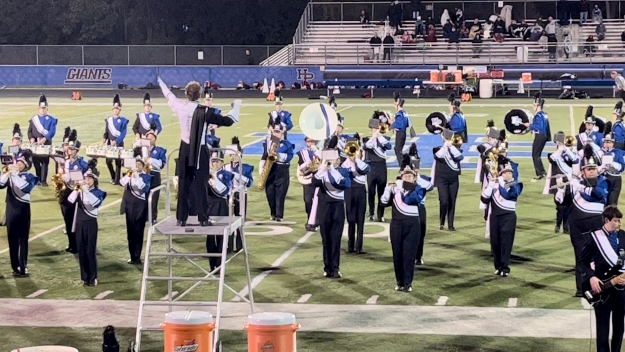 Conducting in front of marching band on field