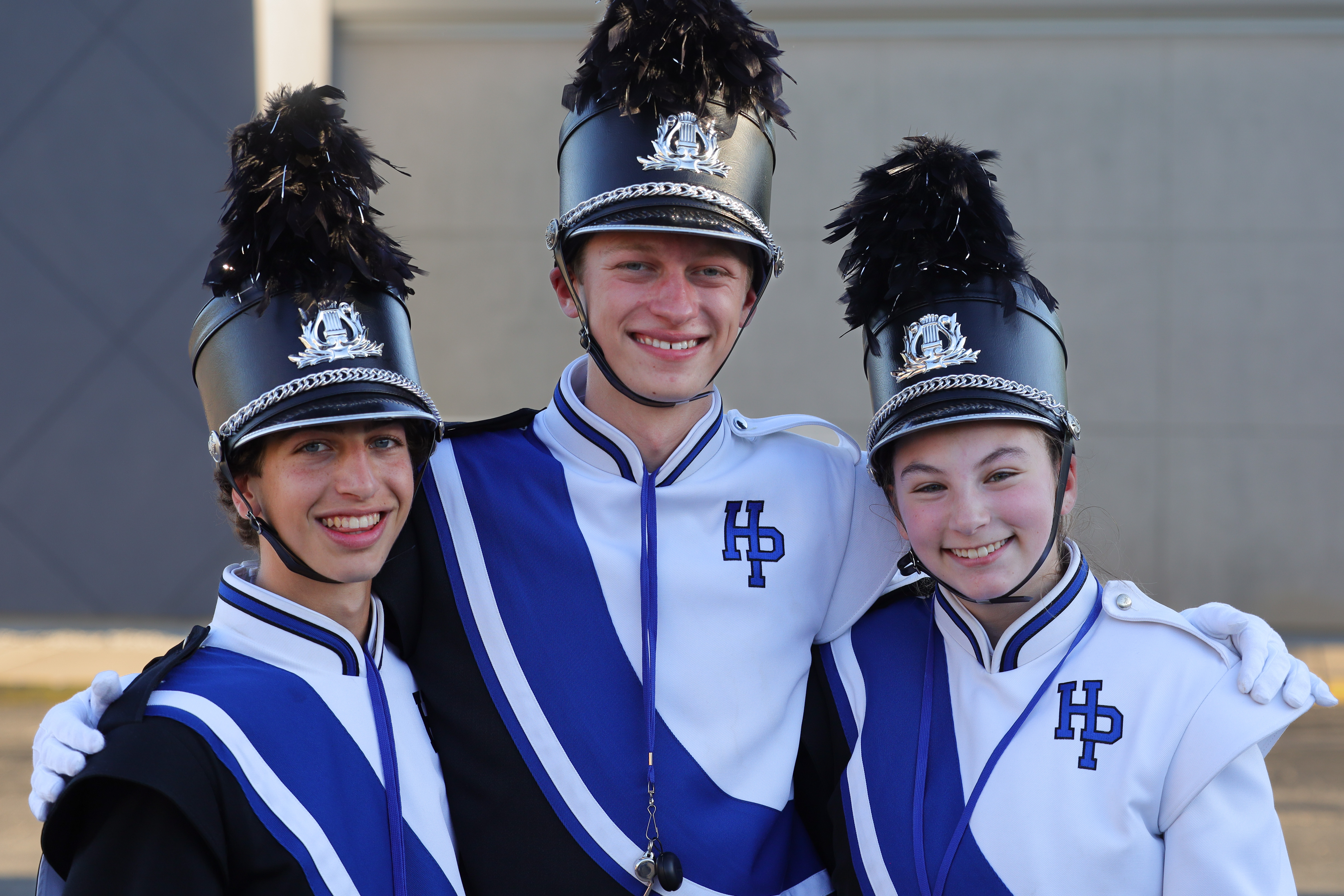 Posed picture of three drum majors