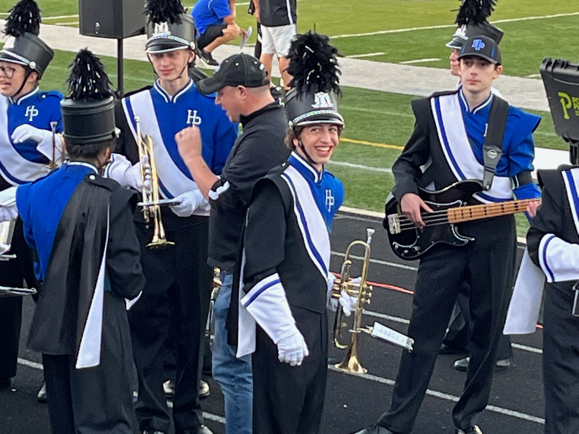 Holding trumpet on track by marching band field