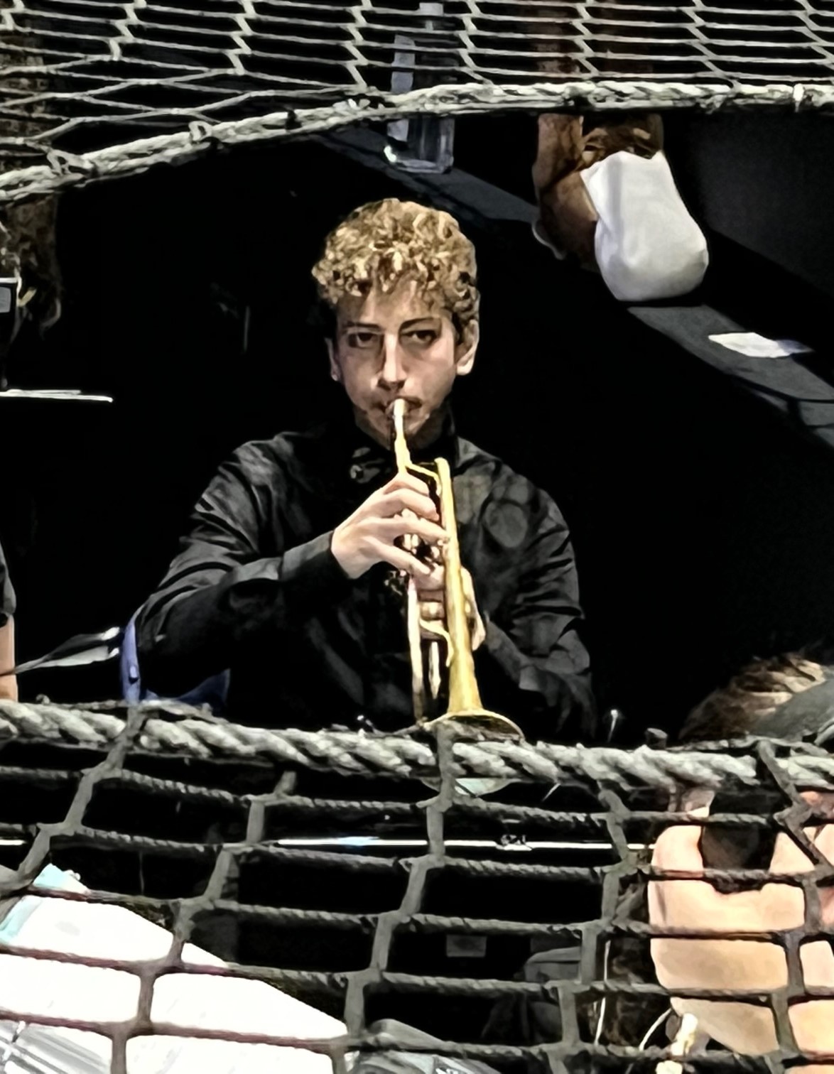 Top-down playing trumpet in orchestra pit